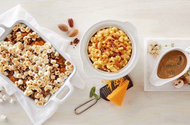 Thanksgiving sides including sweet potato casserole, maccaroni and cheese, and gravy.