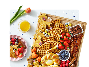 Image of waffles and breakfast items on serving board.
