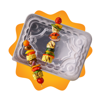 Foil pan with grilled kebabs.
