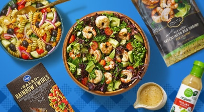 Bowls of fresh pasta salad and greens salad.