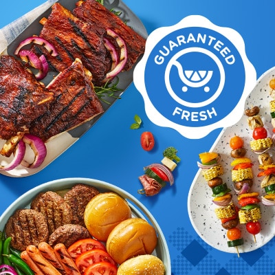 Fresh grilled meat on platter near skewers on plate.