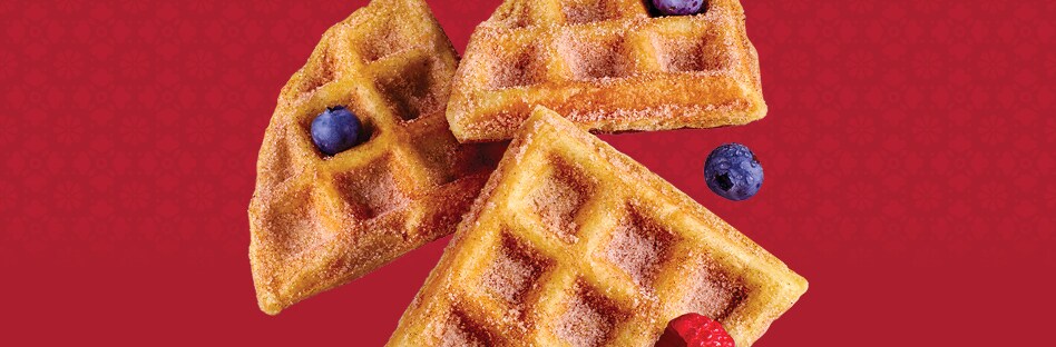 Floating pieces of waffled churros with blueberries and raspberries