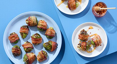 Plated bacon wrapped brussel sprouts drizzled with honey