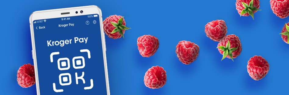 Phone displaying a Kroger Pay QR code surrounded by raspberries.