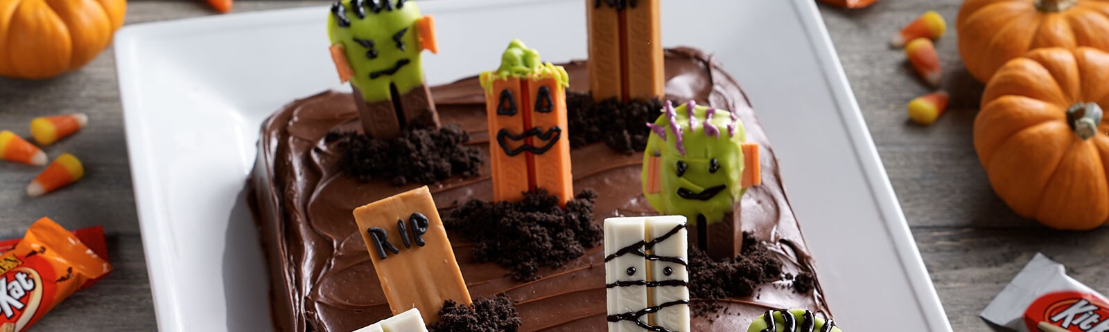 Chocolate cake with Halloween-themed Kit Kat bars placed on top to resemble a spooky graveyard Chocolate cake with Halloween-themed Kit Kat bars placed on top to resemble a spooky graveyard