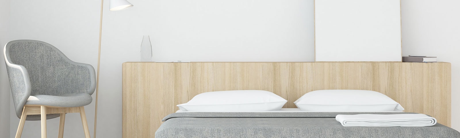 Clean, minimalist bedroom with a grey chair, lamp and bed set Clean, minimalist bedroom with a grey chair, lamp and bed set