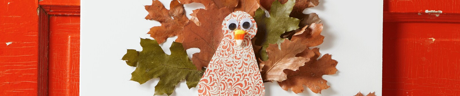 Turkey made with craft paper and hung on a red door Turkey made with craft paper and hung on a red door