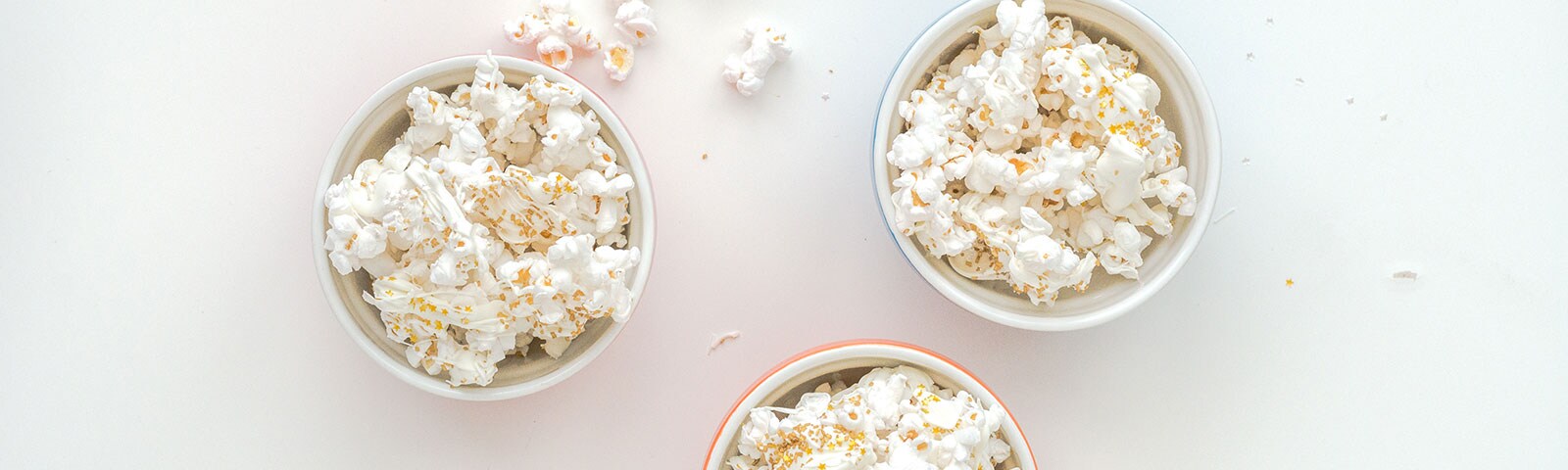 Three bowls of popcorn topped with edible glitter sprinkles Three bowls of popcorn topped with edible glitter sprinkles
