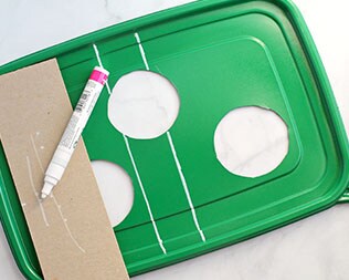 Green rectangle container lid with three holes cut out Green rectangle container lid with three holes cut out